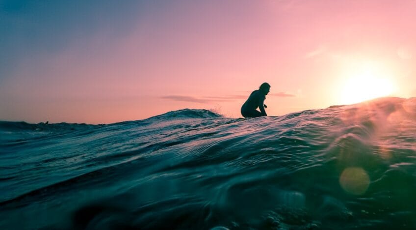 Man Surfing on Ocean Water During Golden Hour SfdwxMA5VIM